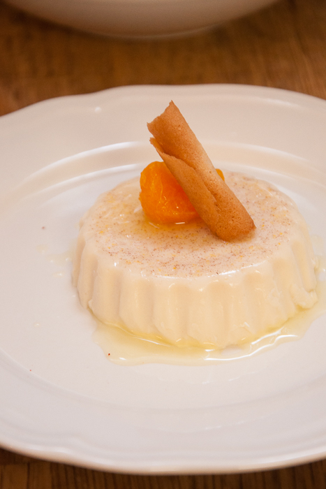 Cinnamon and vanilla panna cotta with stewed clementine and coconut tuille